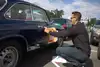 Bernhard Eder bringt den Startaufkleber der Vienna Classic Days an seinem alten Alfa Romeo an